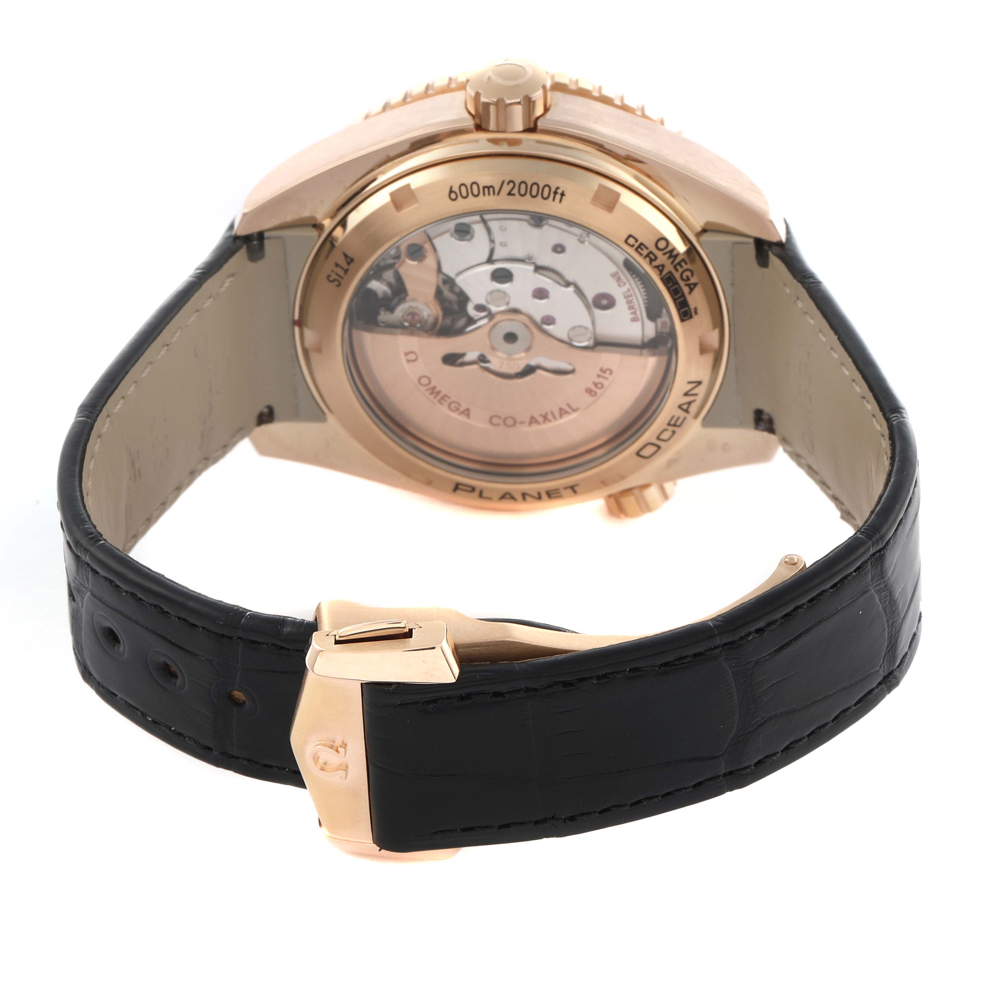 The Omega Planet Ocean 232.63.44.22.01.001 Men's Rose Gold Black Dial 232.63.44.22.01.001 Men's Rose Gold Black Dial watch is shown from the back, highlighting its movement and black leather strap with a gold clasp.