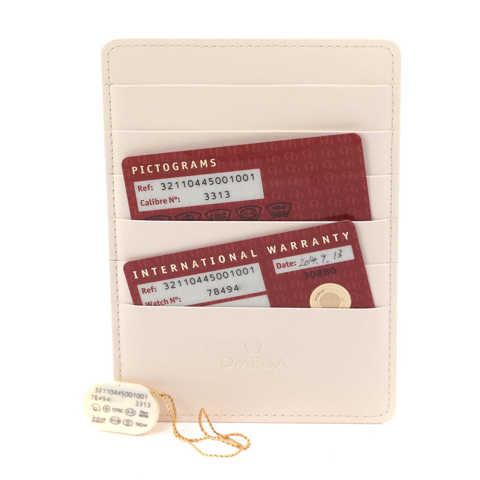 The image shows Omega Speedmaster 321.10.44.50.01.001 Men
s Stainless Steel Black Dial 321.10.44.50.01.001 Men
s Stainless Steel Black Dial model cards in a cream cardholder, with pictogram and warranty details visible.