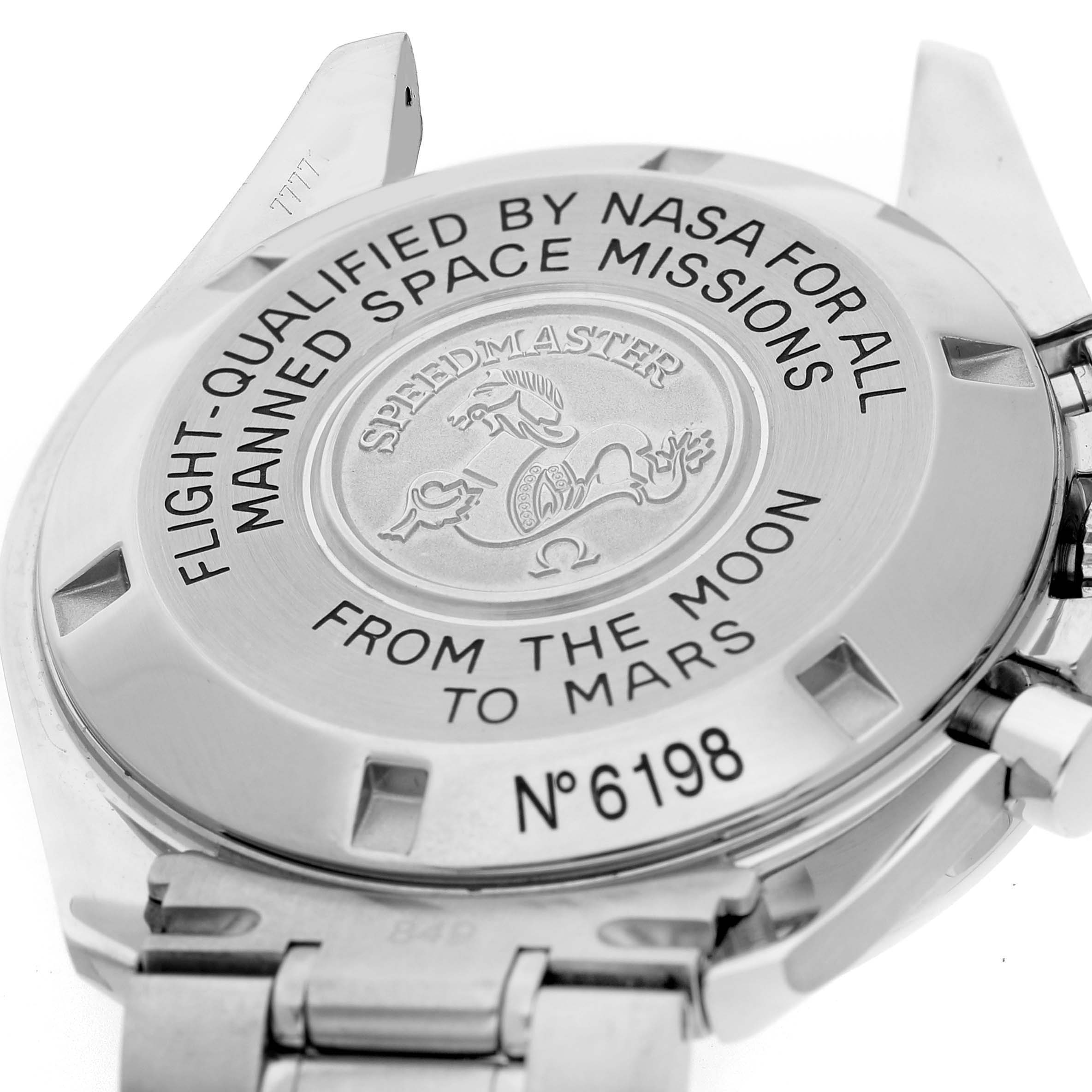 The image shows the case back of an Omega Speedmaster 3577.50.00 Men's Stainless Steel Black Dial watch, highlighting engraved details and metal links.