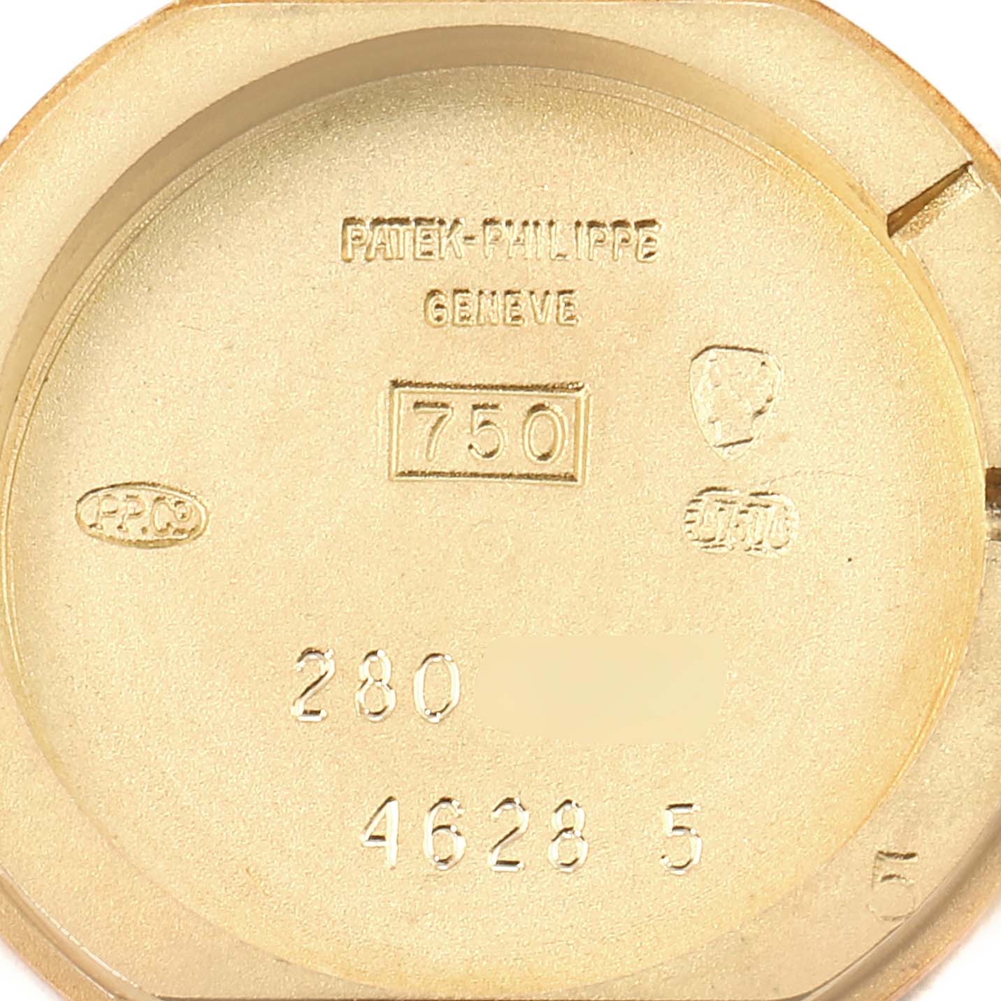 The image shows the inner case back of a Vintage Patek Philippe watch with various markings and engravings.