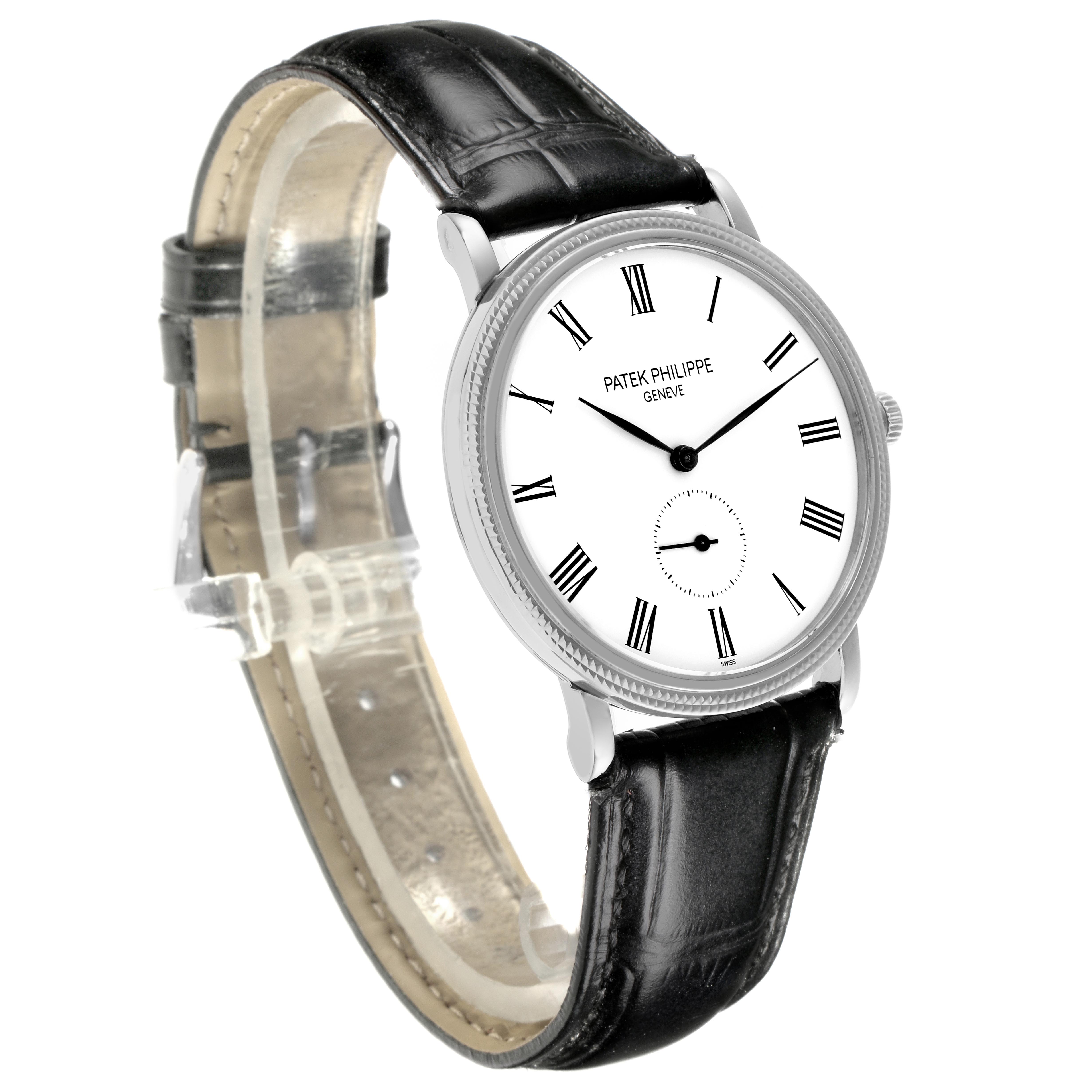 The Patek Philippe Calatrava 5119G-001 Men's White Gold White Dial 5119G-001 Men's White Gold White Dial watch is shown from a front angle, highlighting its white dial, Roman numerals, and black leather strap.