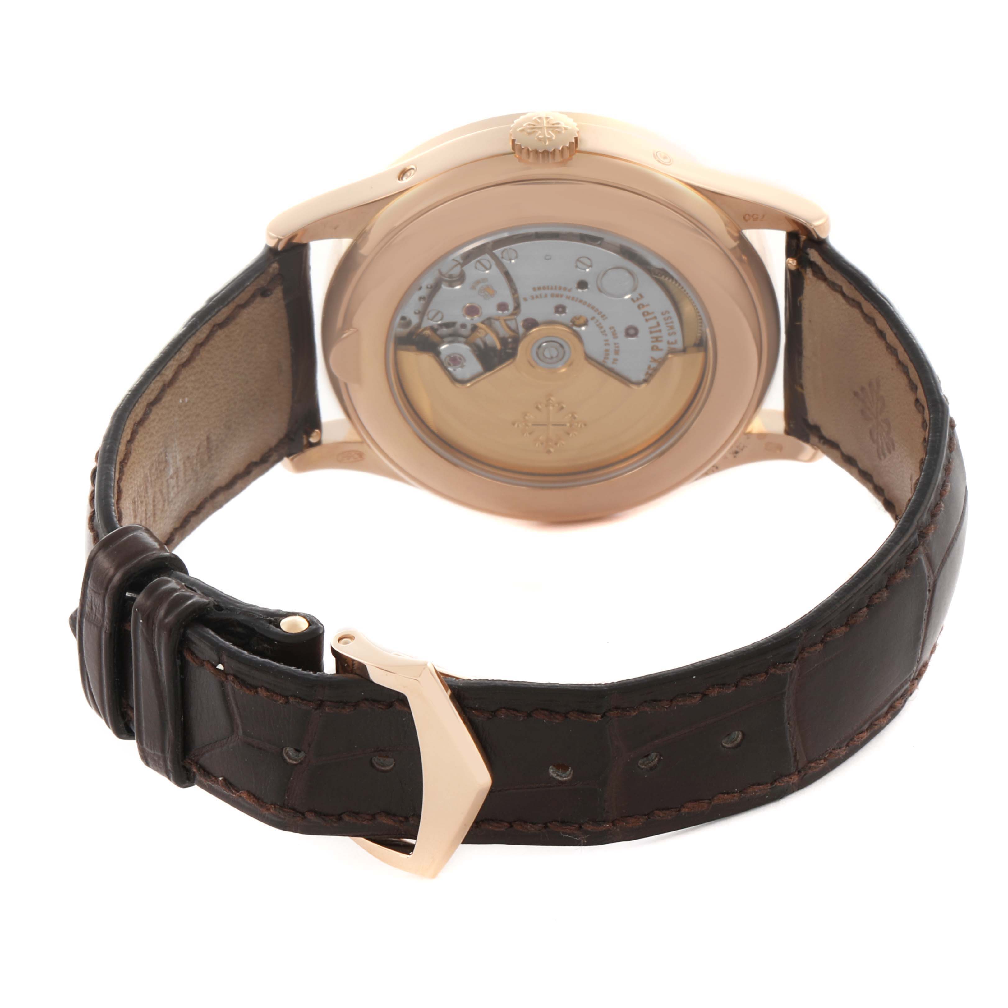 The Patek Philippe Complications 5396R-001 Men's Rose Gold Silver Dial 5396R-001 Men's Rose Gold Silver Dial watch is shown from the back, highlighting the exposed movement and leather strap.