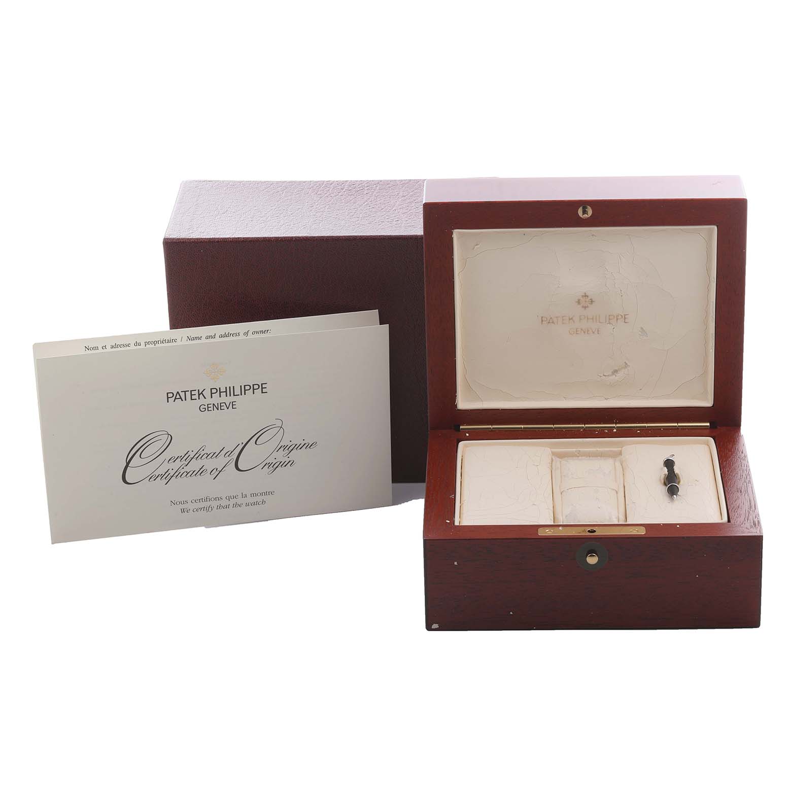 The image shows a Patek Philippe Complications 5396R-001 Men's Rose Gold Silver Dial 5396R-001 Men's Rose Gold Silver Dial box, certificate, and watch accessory tool from a front angle.