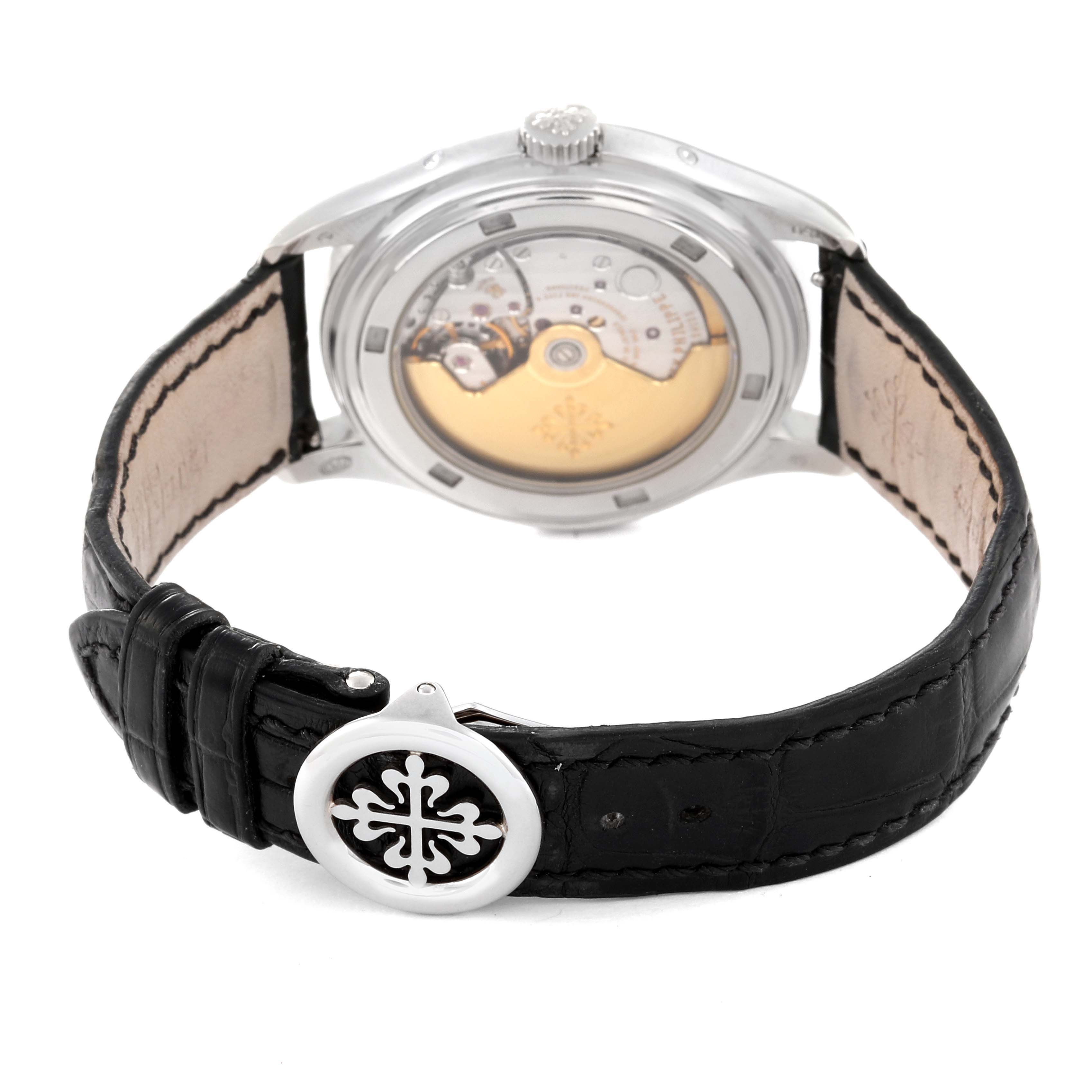 The image shows the back view of the Patek Philippe Complications 5146G Men's White Gold Beige Dial 5146G Men's White Gold Beige Dial watch, highlighting the transparent case back and the black leather strap.