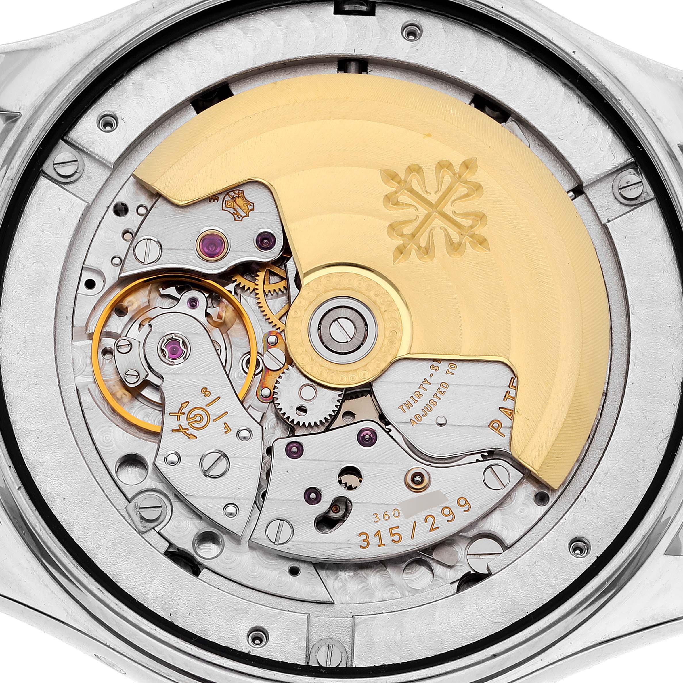 The image shows the back view of the Patek Philippe Complications 5146G Men's White Gold Beige Dial 5146G Men's White Gold Beige Dial model, displaying its intricate automatic movement and rotor.