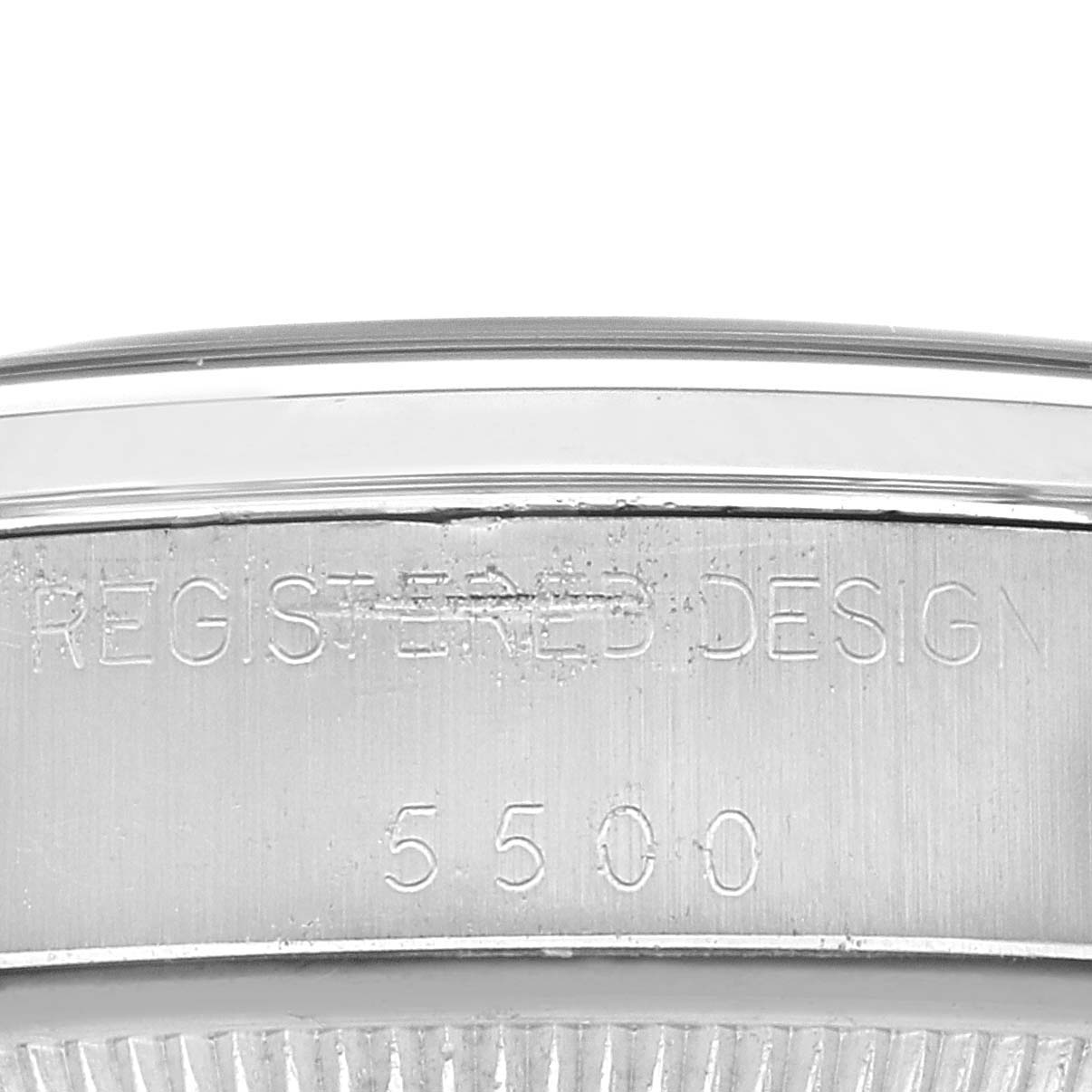 This image displays the side of a Rolex Vintage Collection 5500 Men's Stainless Steel Silver Dial 5500 Men's Stainless Steel Silver Dial watch, showcasing the engraved "REGISTERED DESIGN" and "5500" markings.