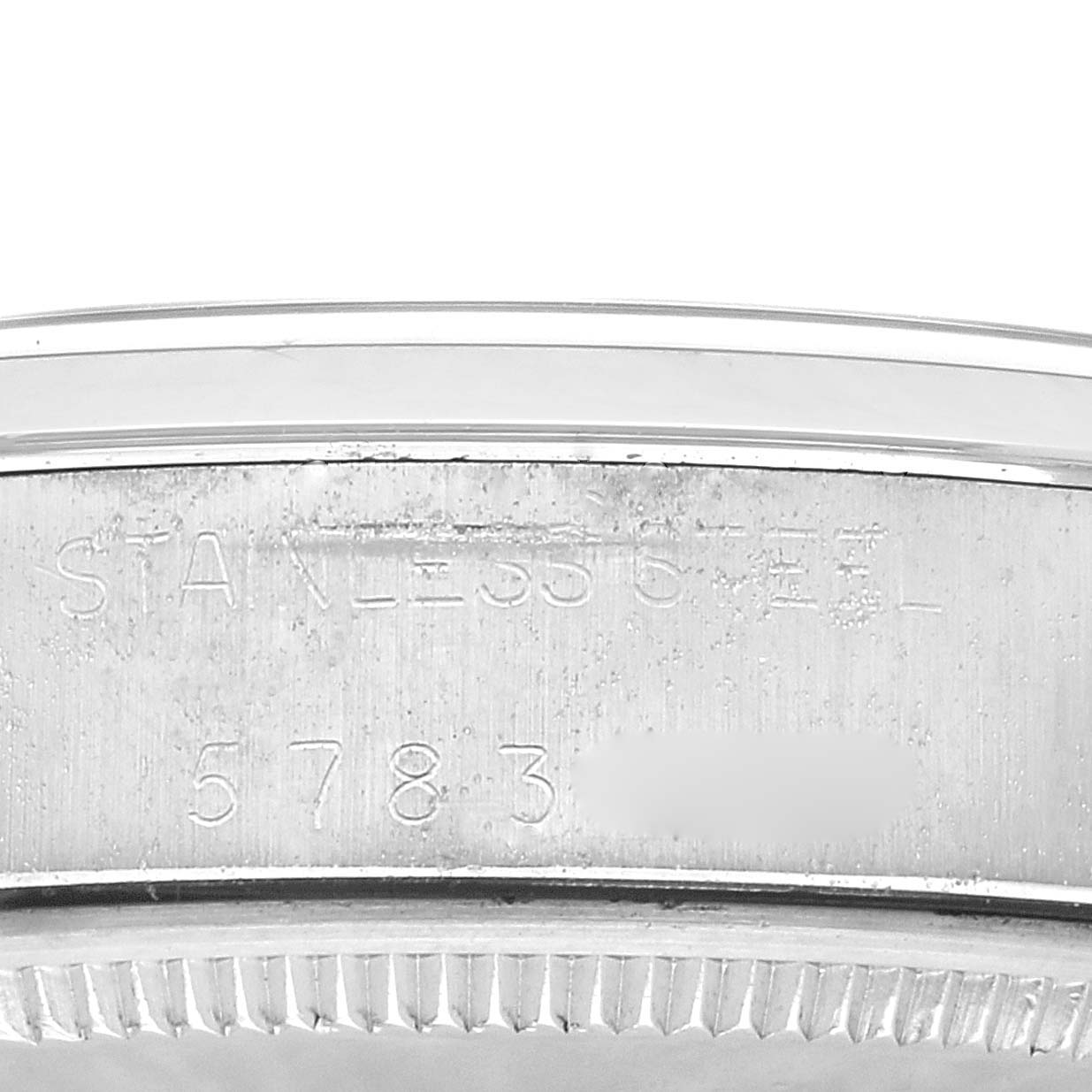 The image shows a close-up view of the side of a Rolex Vintage Collection 5500 Men's Stainless Steel Silver Dial 5500 Men's Stainless Steel Silver Dial watch, highlighting the stainless steel marking and partial serial number.