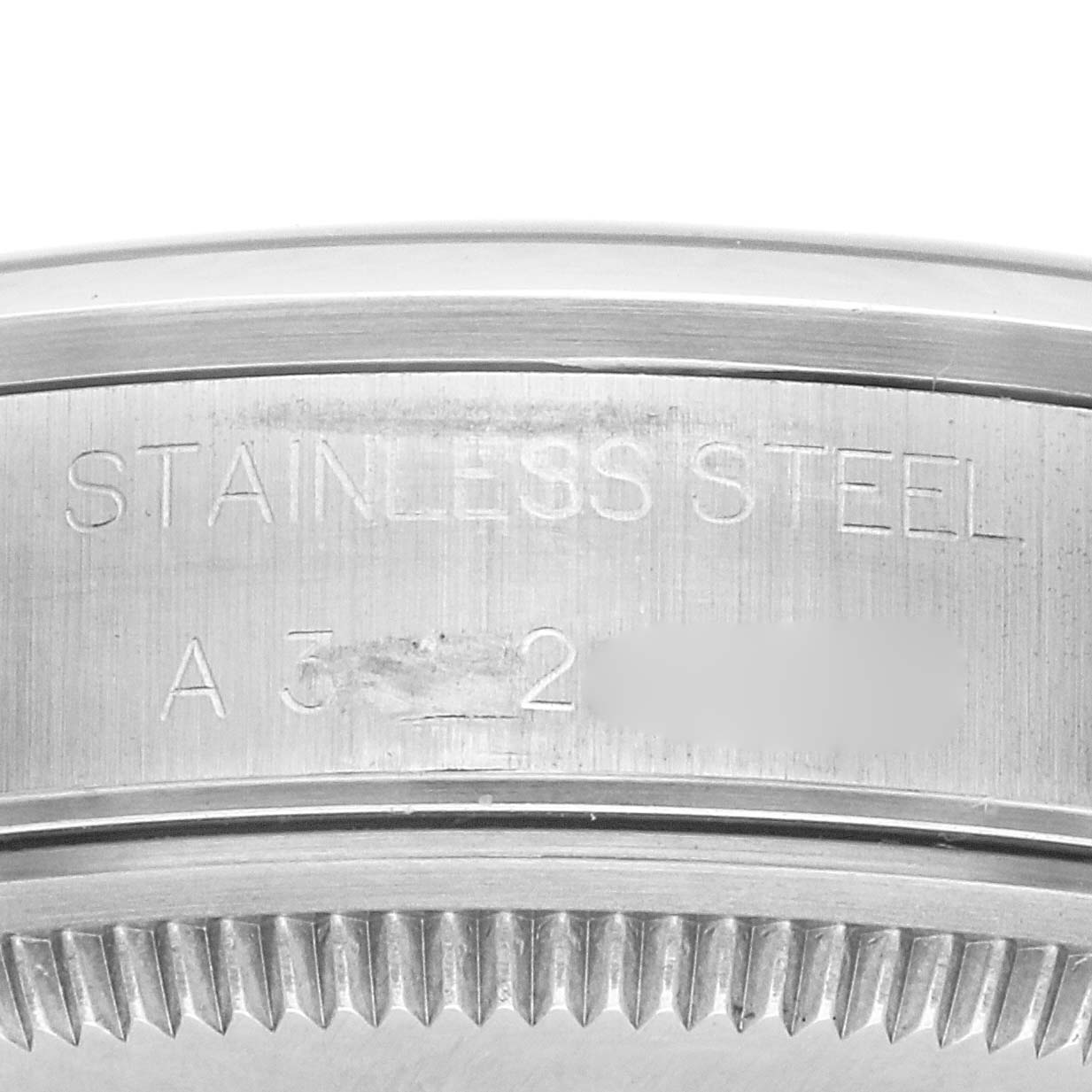 The image shows a close-up of the case side of a Rolex Air-King 14000 Men's Stainless Steel Pink Dial 14000 Men's Stainless Steel Pink Dial watch, highlighting the "STAINLESS STEEL" engraving.