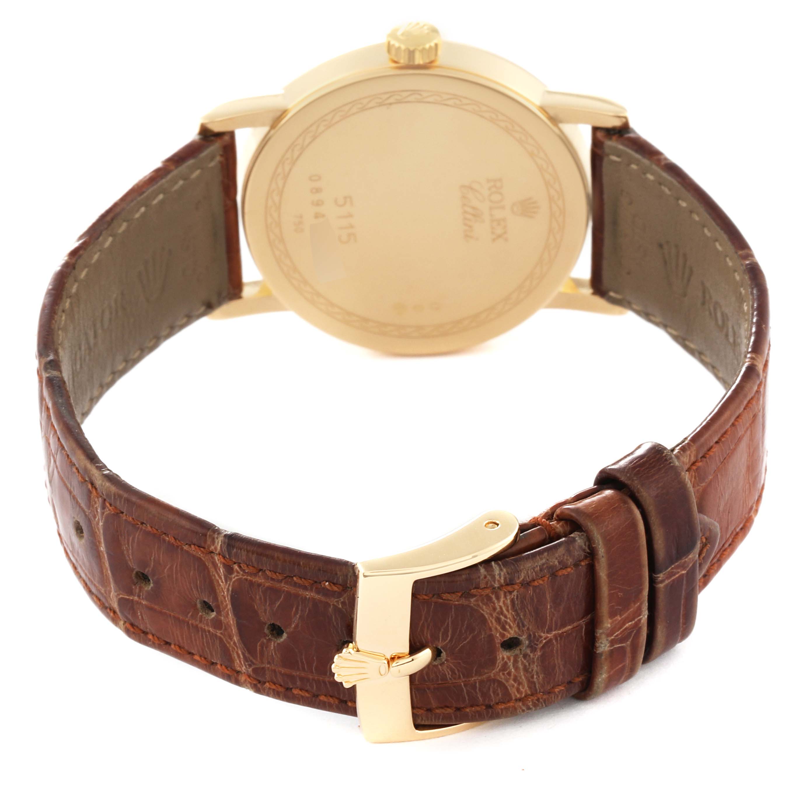 The image shows the back view of a Rolex Cellini 5115 Men
s Yellow Gold Mother of Pearl Dial 5115 Men
s Yellow Gold Mother of Pearl Dial watch, featuring its closed leather strap and gold clasp.