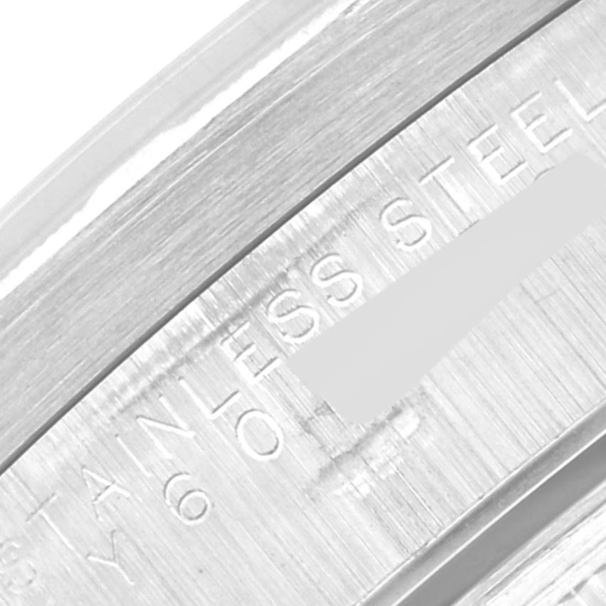 This close-up image shows the engraved inner rim detail of a Rolex Date 15210 Men's Stainless Steel Blue Dial 15210 Men's Stainless Steel Blue Dial model watch, highlighting "STAINLESS STEEL".