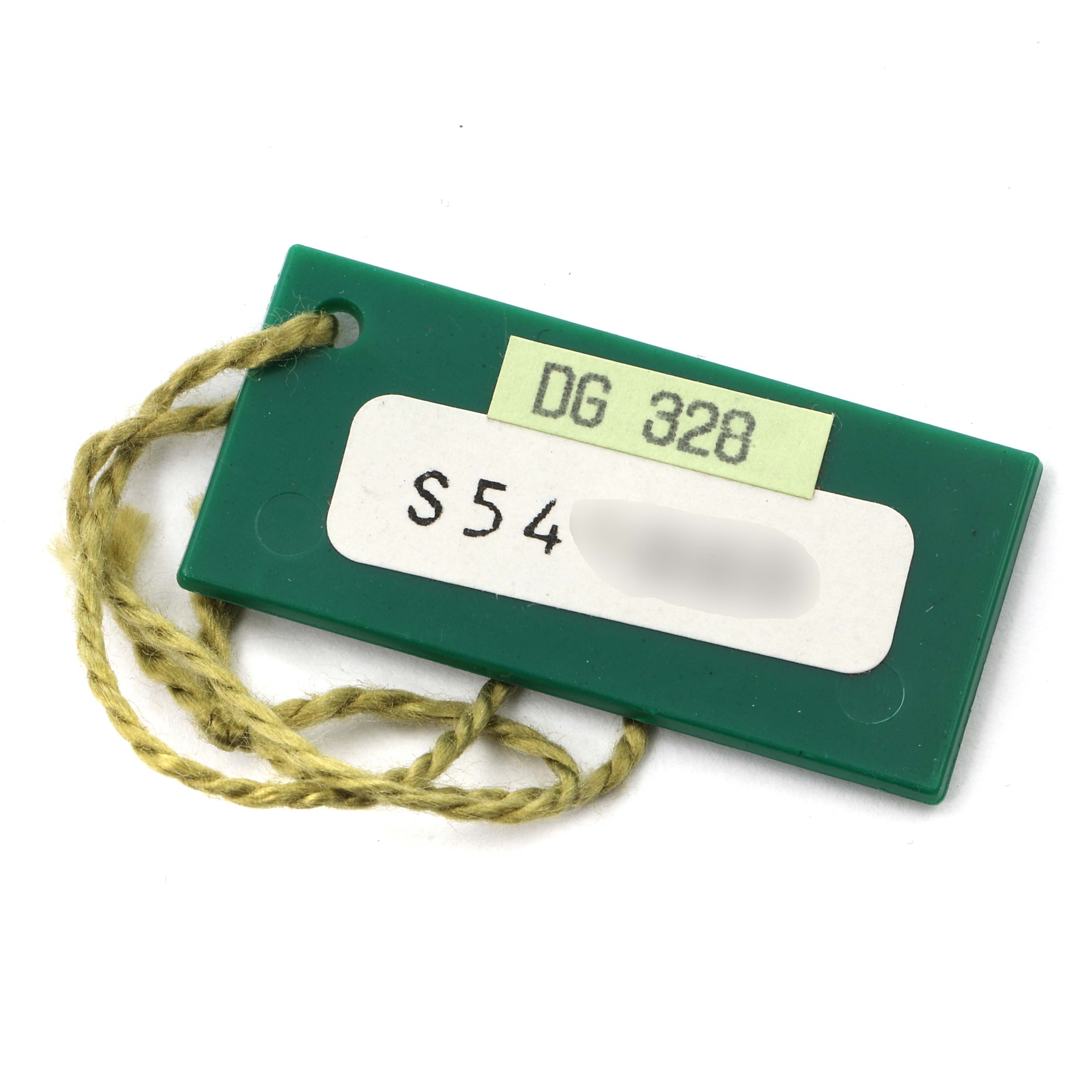 This image shows a green tag with string, likely an accessory for a Rolex Datejust 69173 Women's Steel and Gold (two tone) Champagne Dial 69173 Women's Steel and Gold (two tone) Champagne Dial watch.