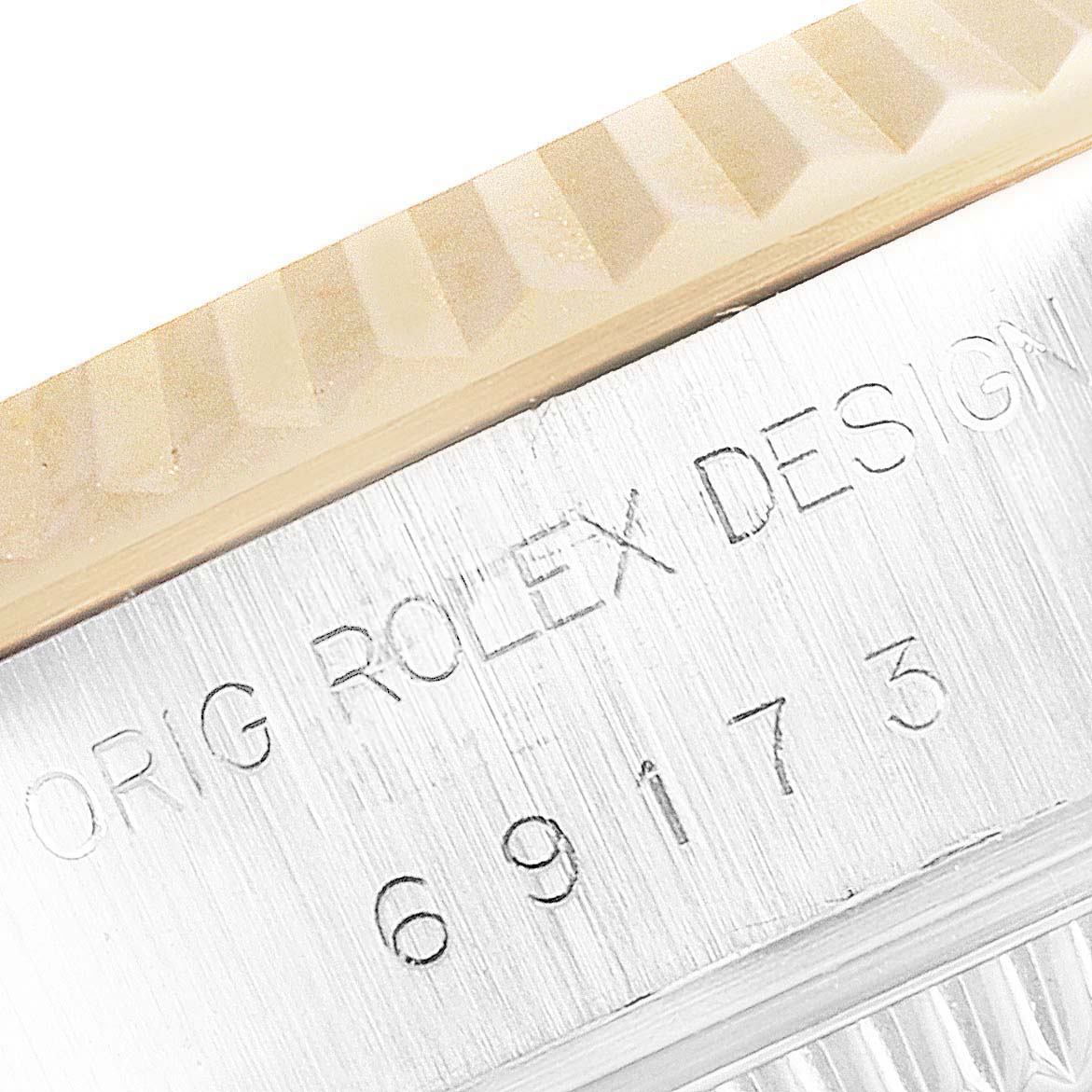 The image shows a close-up of the bezel and case engraving on a Rolex Datejust 69173 Women's Steel and Gold (two tone) Champagne Dial 69173 Women's Steel and Gold (two tone) Champagne Dial watch.