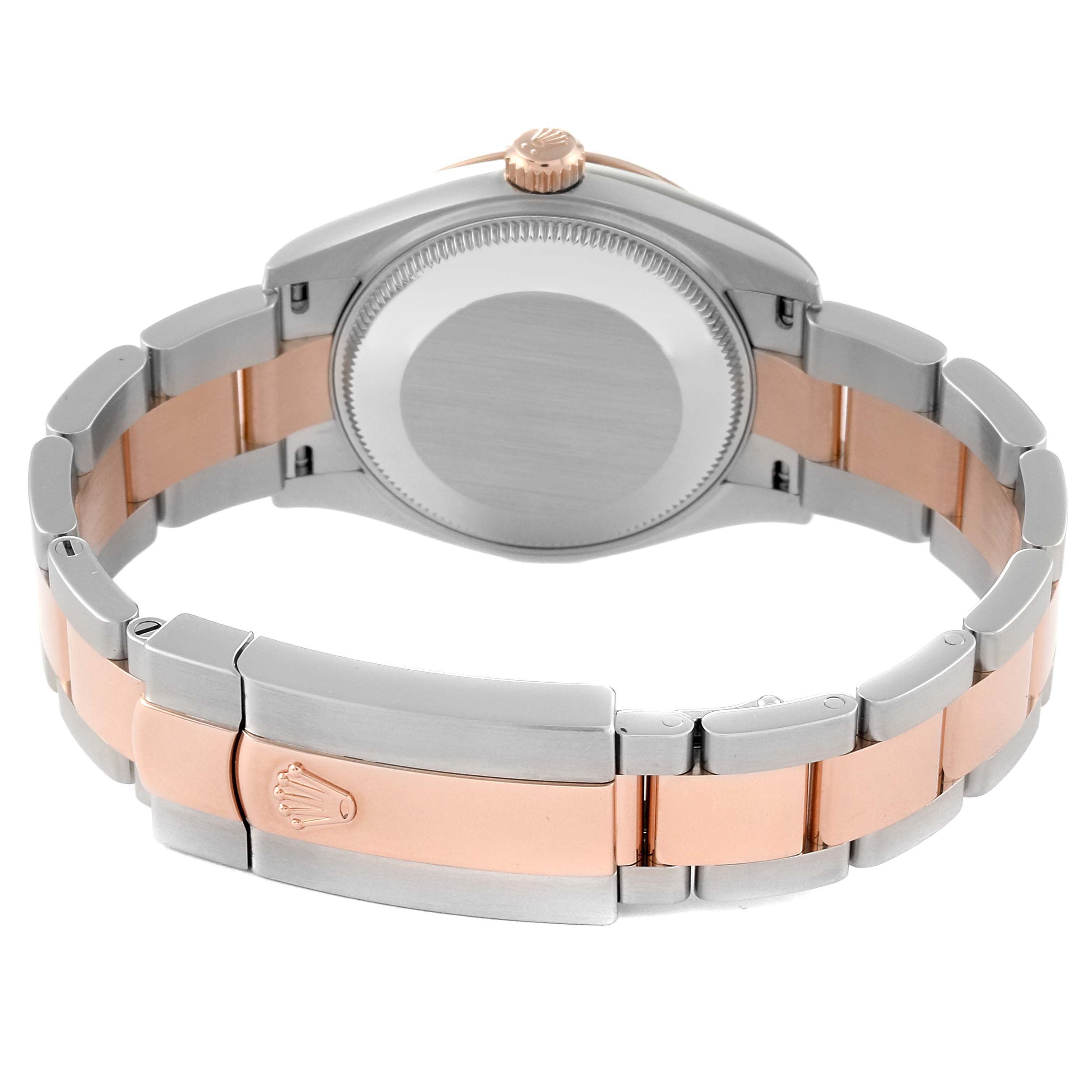 This image shows the back view and bracelet of a Mid-Size Rolex watch, highlighting the two-tone metal design and clasp with Rolex logo.