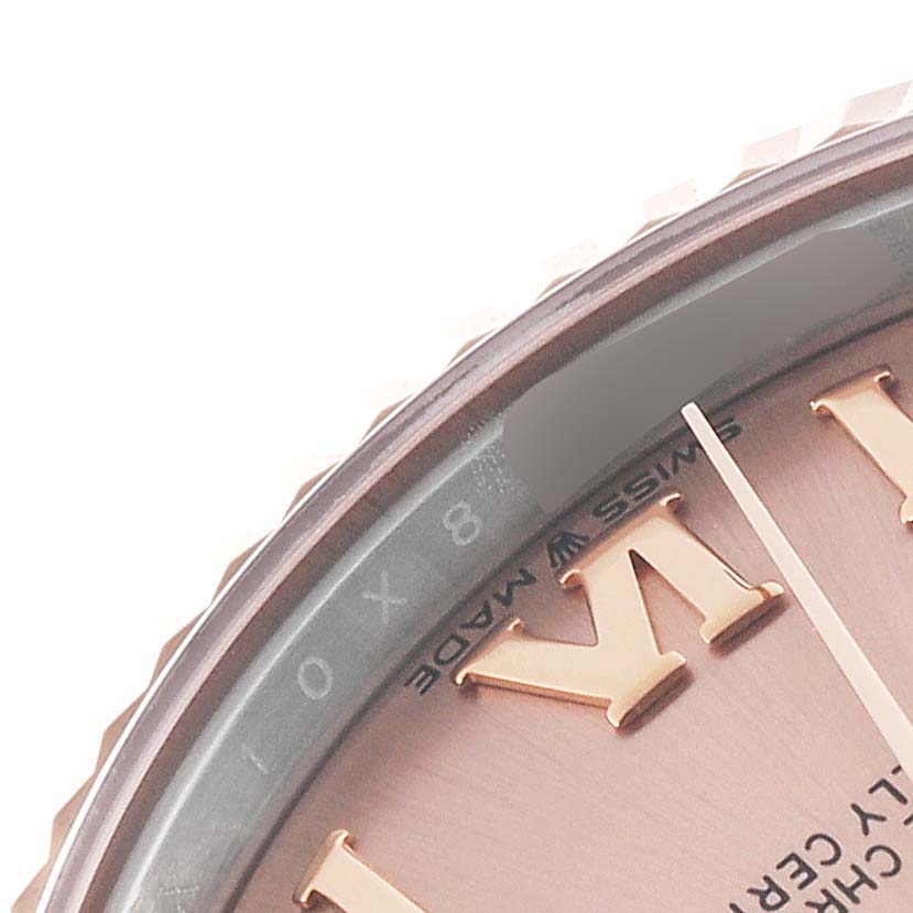 The image shows a close-up of the dial and bezel of a mid-size Rolex watch.
