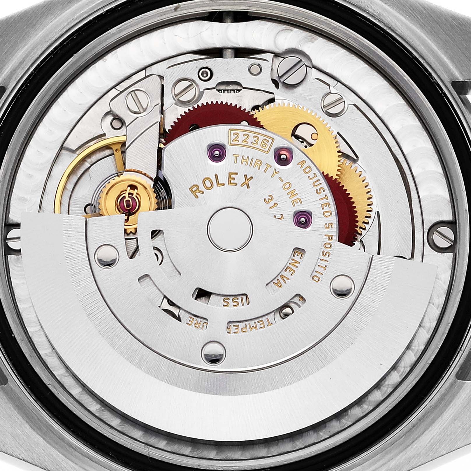 The image shows the movement mechanism of a Mid-Size Rolex watch from a rear angle, highlighting gears and the rotor.