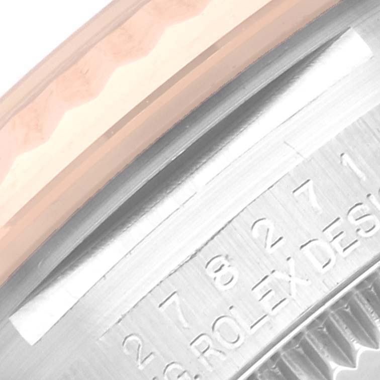 This image shows a close-up of the bezel and engraved details on a Rolex Mid-Size 278271 Women's Steel and Gold (two tone) White Dial 278271 Women's Steel and Gold (two tone) White Dial model watch.