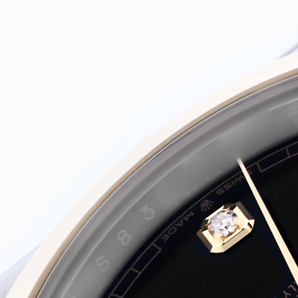 This image shows a close-up of the dial and bezel of the Rolex Datejust 41 126303 Men's Steel and Gold (two tone) Black Dial 126303 Men's Steel and Gold (two tone) Black Dial, highlighting the diamond marker.