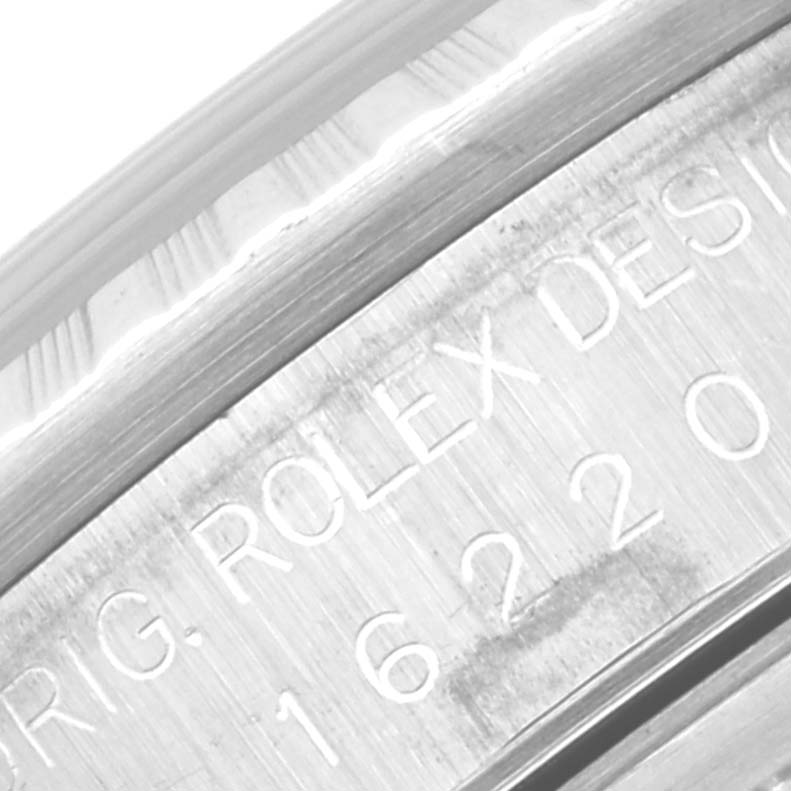 This close-up image of the Rolex Datejust 16220 Men's Stainless Steel Blue Dial 16220 Men's Stainless Steel Blue Dial watch shows the engraved inner bezel with part of the model number and branding.