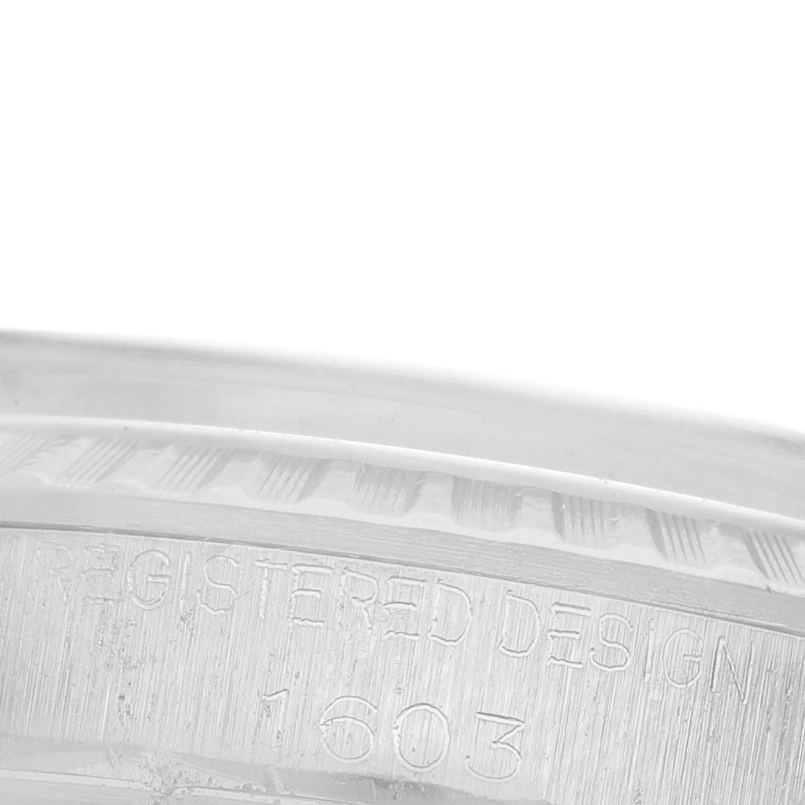 The image shows a close-up of the engraved side of the bezel of a Rolex Datejust 1603 Men's Stainless Steel Blue Dial 1603 Men's Stainless Steel Blue Dial watch.