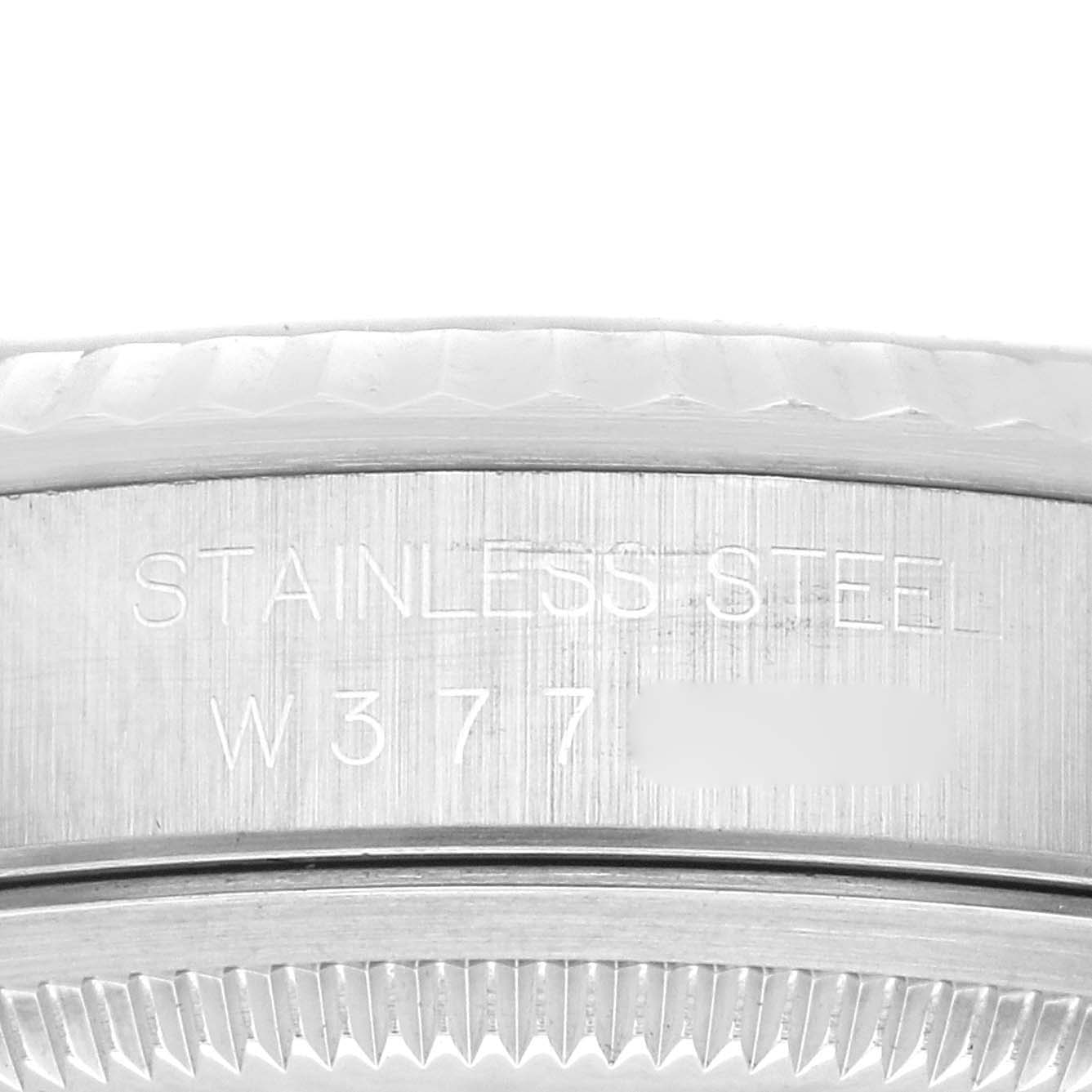 This image shows a close-up of the engraved bezel and case of a Rolex Datejust 16234 Men's Stainless Steel Blue Dial 16234 Men's Stainless Steel Blue Dial watch, highlighting "STAINLESS STEEL" text.