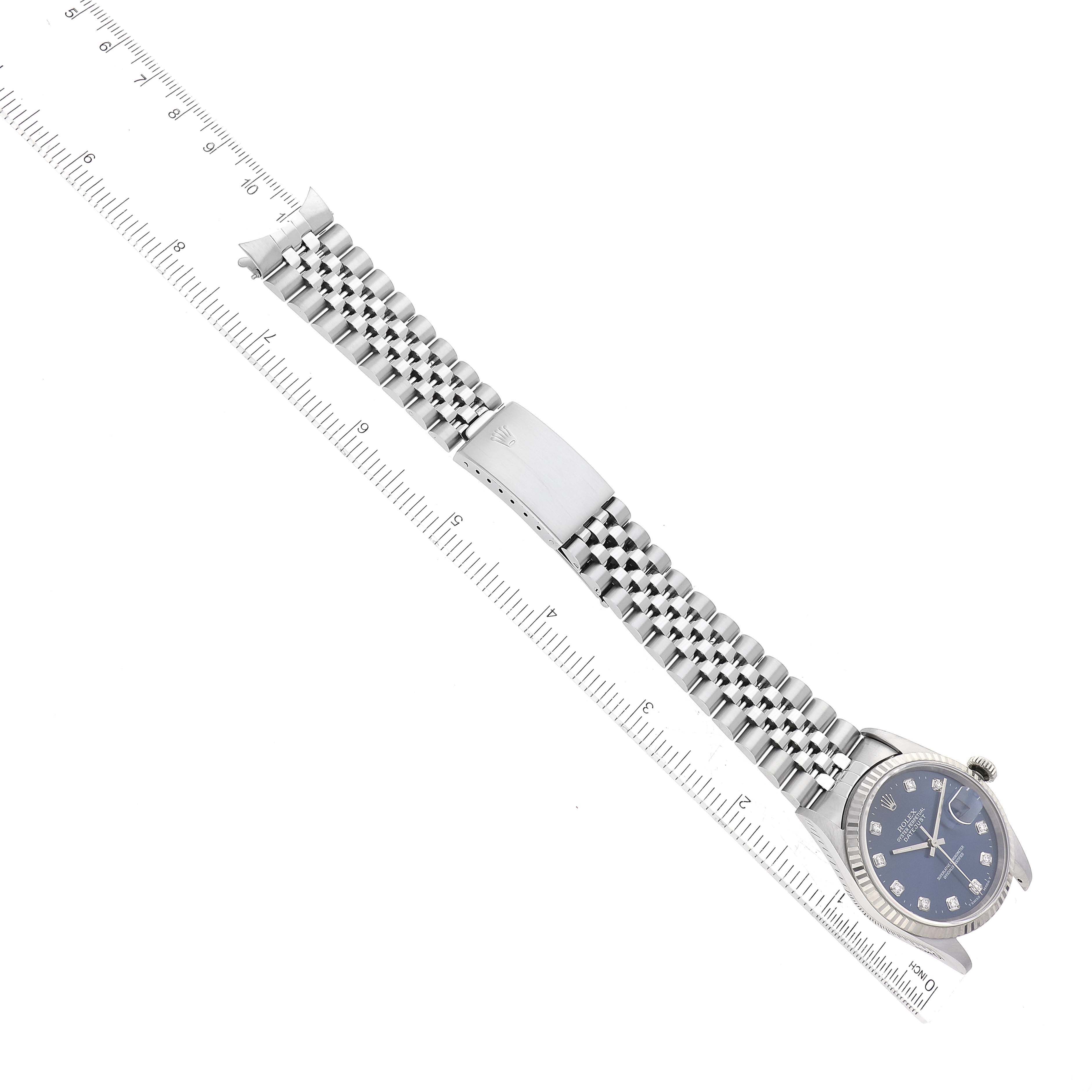 The image shows a top-down view of a Rolex Datejust 16234 Men's Stainless Steel Blue Dial 16234 Men's Stainless Steel Blue Dial watch, highlighting the face, bezel, and metal bracelet with a ruler for scale.