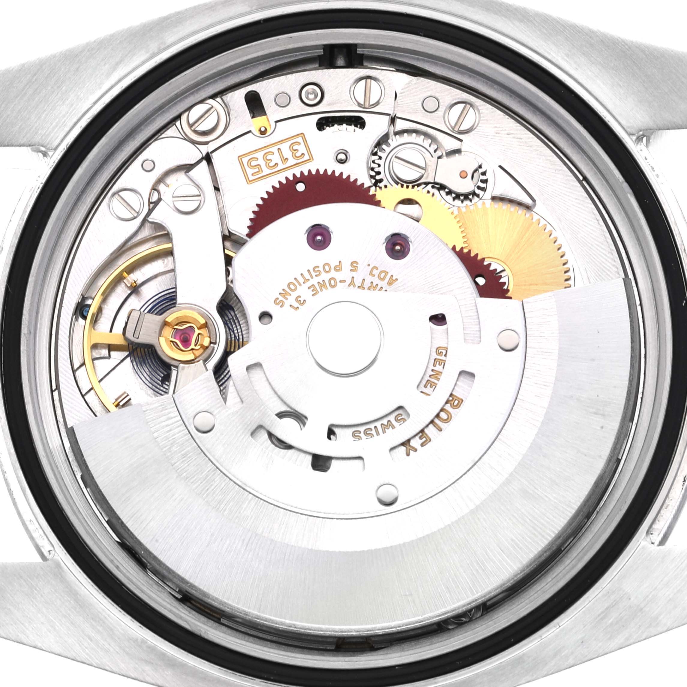 This image shows the internal mechanism and movement of a Rolex Datejust 116200 Men's Stainless Steel Blue Dial 116200 Men's Stainless Steel Blue Dial watch from a rear angle.