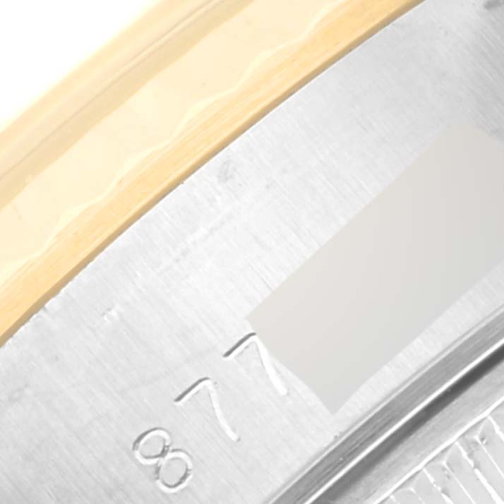 This is a close-up of the side of the Rolex Datejust 69173 Women's Steel and Gold (two tone) Champagne Dial 69173 Women's Steel and Gold (two tone) Champagne Dial watch case, showing part of the serial number engraving.