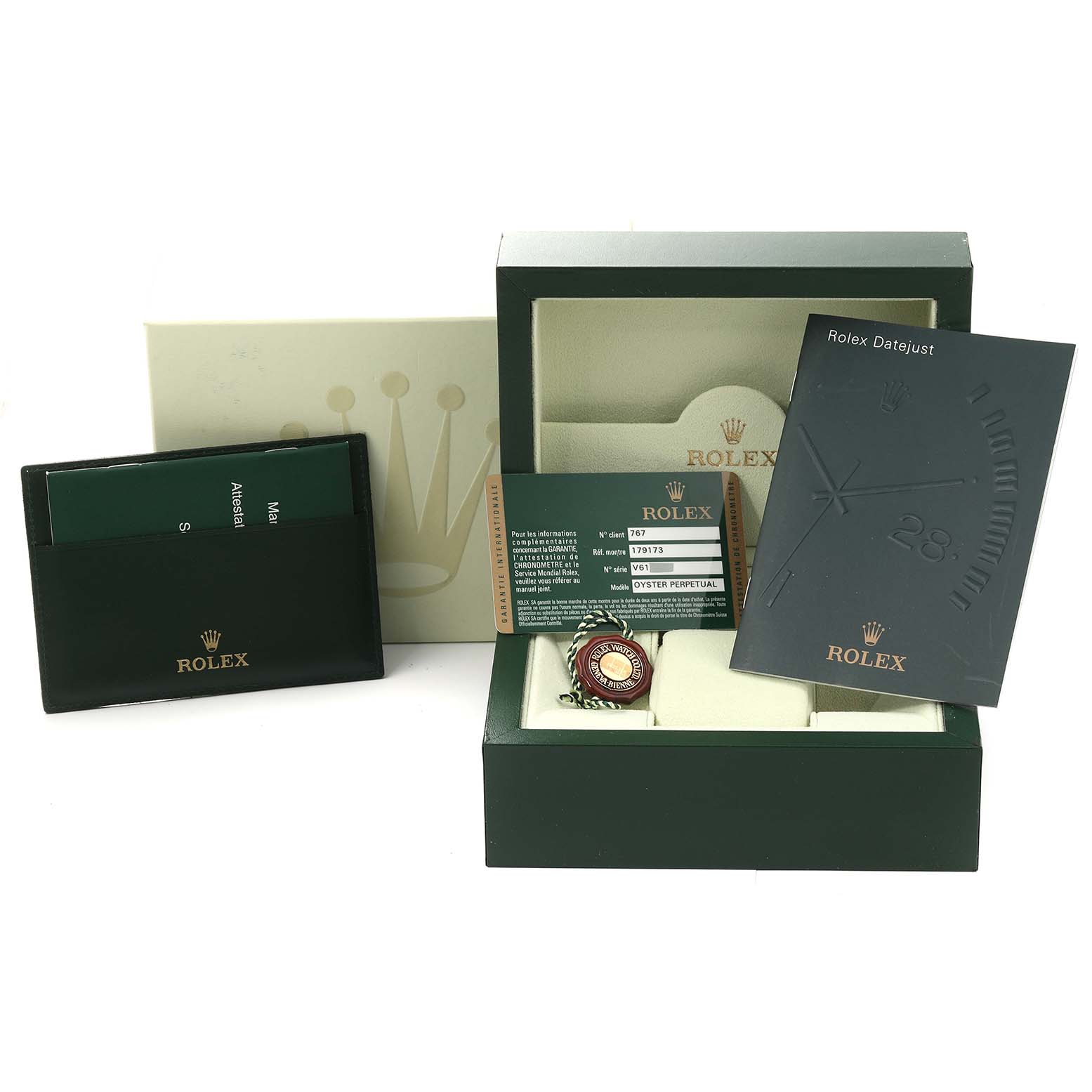 The image shows the packaging, warranty card, booklet, and tag of a Rolex Datejust 179173 Women's Steel and Gold (two tone) Black Dial 179173 Women's Steel and Gold (two tone) Black Dial watch, viewed from the front.