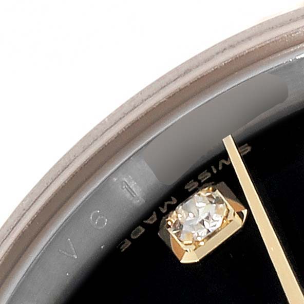 This image shows an up-close view of the dial, gemstone marker, and part of the bezel of a Rolex Datejust 179173 Women's Steel and Gold (two tone) Black Dial 179173 Women's Steel and Gold (two tone) Black Dial watch.