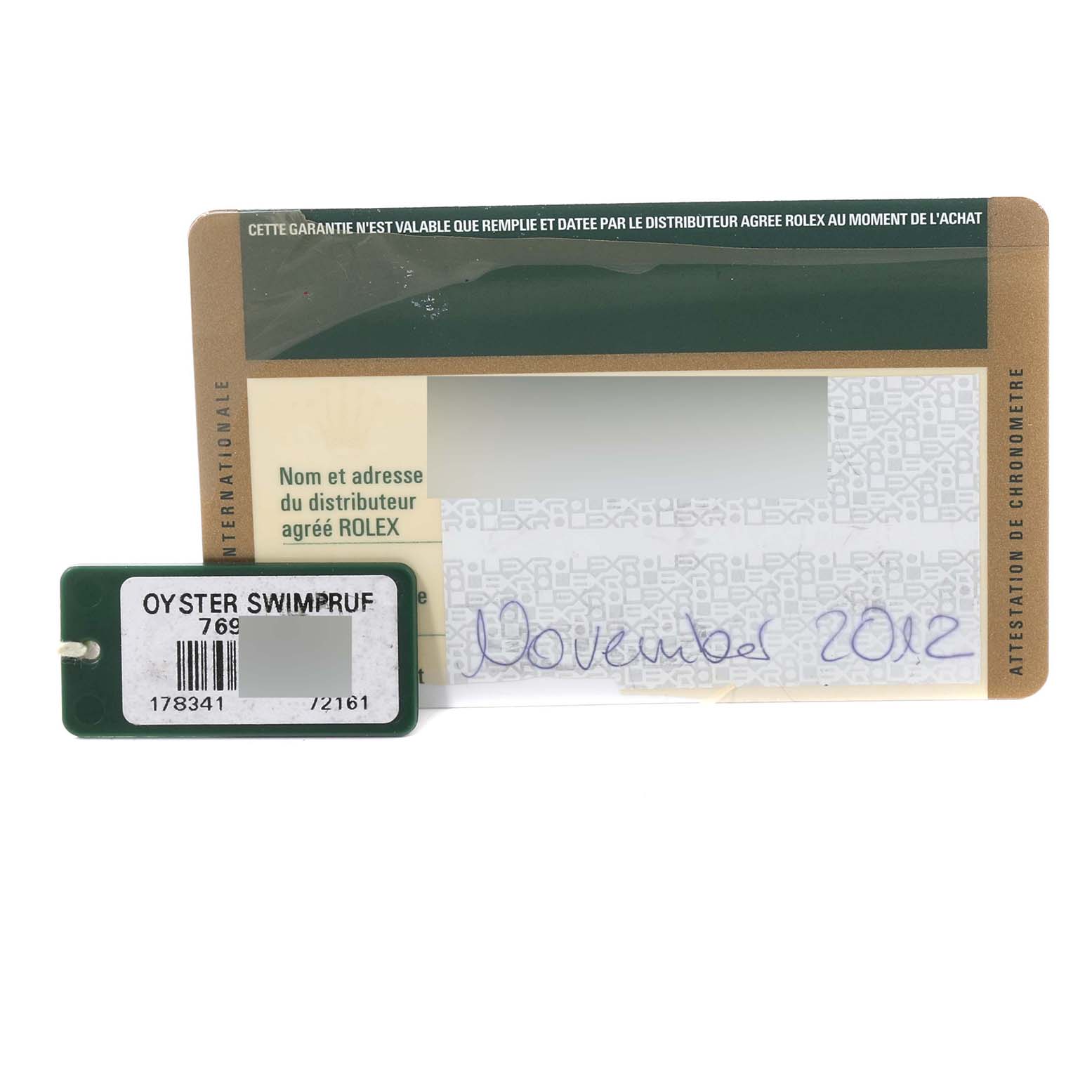 The image shows a warranty card and an Oyster Swimpruf tag for a Mid-Size Rolex watch, dated November 2012.