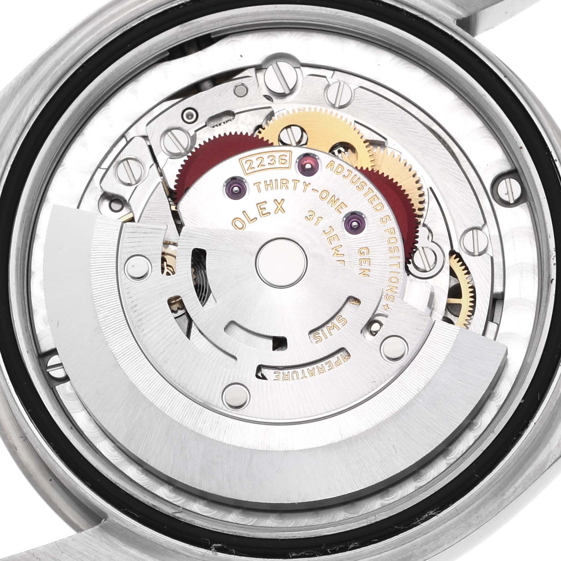 The image shows a close-up view of the movement and internal mechanism of the Mid-Size Rolex watch.