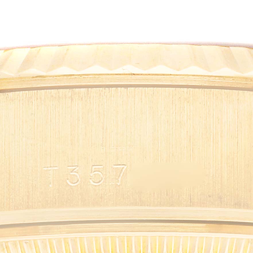 This close-up image shows the side of the bezel and part of the case with serial numbers of a Rolex President 69178 Women's Yellow Gold Silver Dial 69178 Women's Yellow Gold Silver Dial model watch.