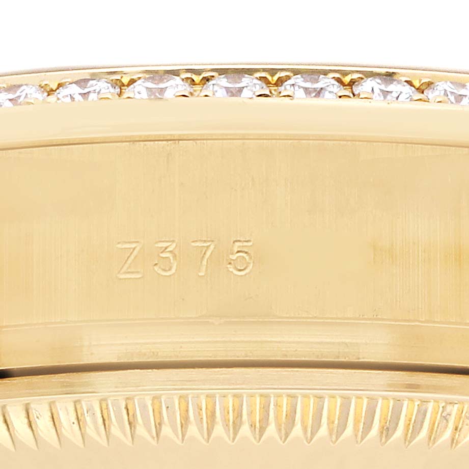 The image shows a close-up of a Rolex President 179158 Women's Yellow Gold Mother of Pearl Dial 179158 Women's Yellow Gold Mother of Pearl Dial model, highlighting a section of the bezel with embedded diamonds and a textured edge.