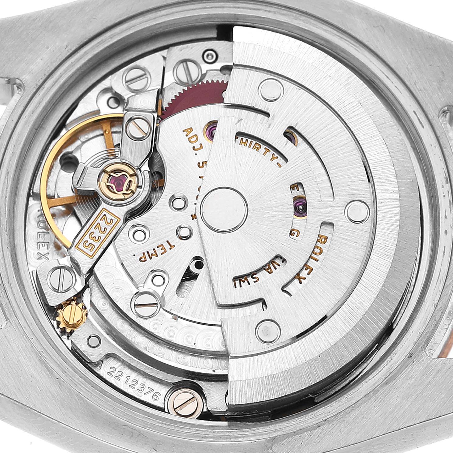 The image shows a close-up of the Rolex Datejust 179161 Women's Steel and Gold (two tone) Black Dial movement from the back, highlighting the rotor and various intricate components.