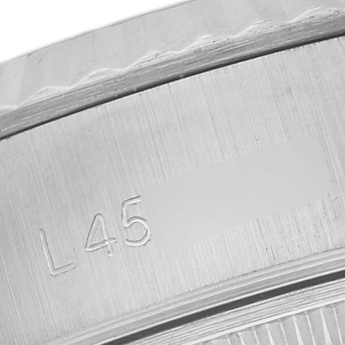 The image shows a close-up of the serial number area on the side of the Rolex Datejust 69174 Women's Stainless Steel Black Dial 69174 Women's Stainless Steel Black Dial watch case.