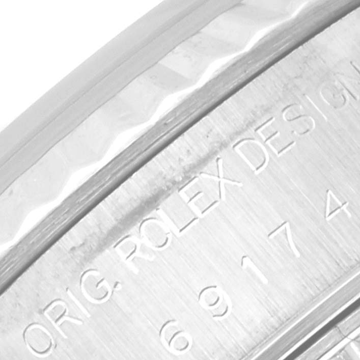 This close-up image shows the engraved side of the bezel and part of the case of the Rolex Datejust 69174 Women's Stainless Steel Silver Dial 69174 Women's Stainless Steel Silver Dial watch.