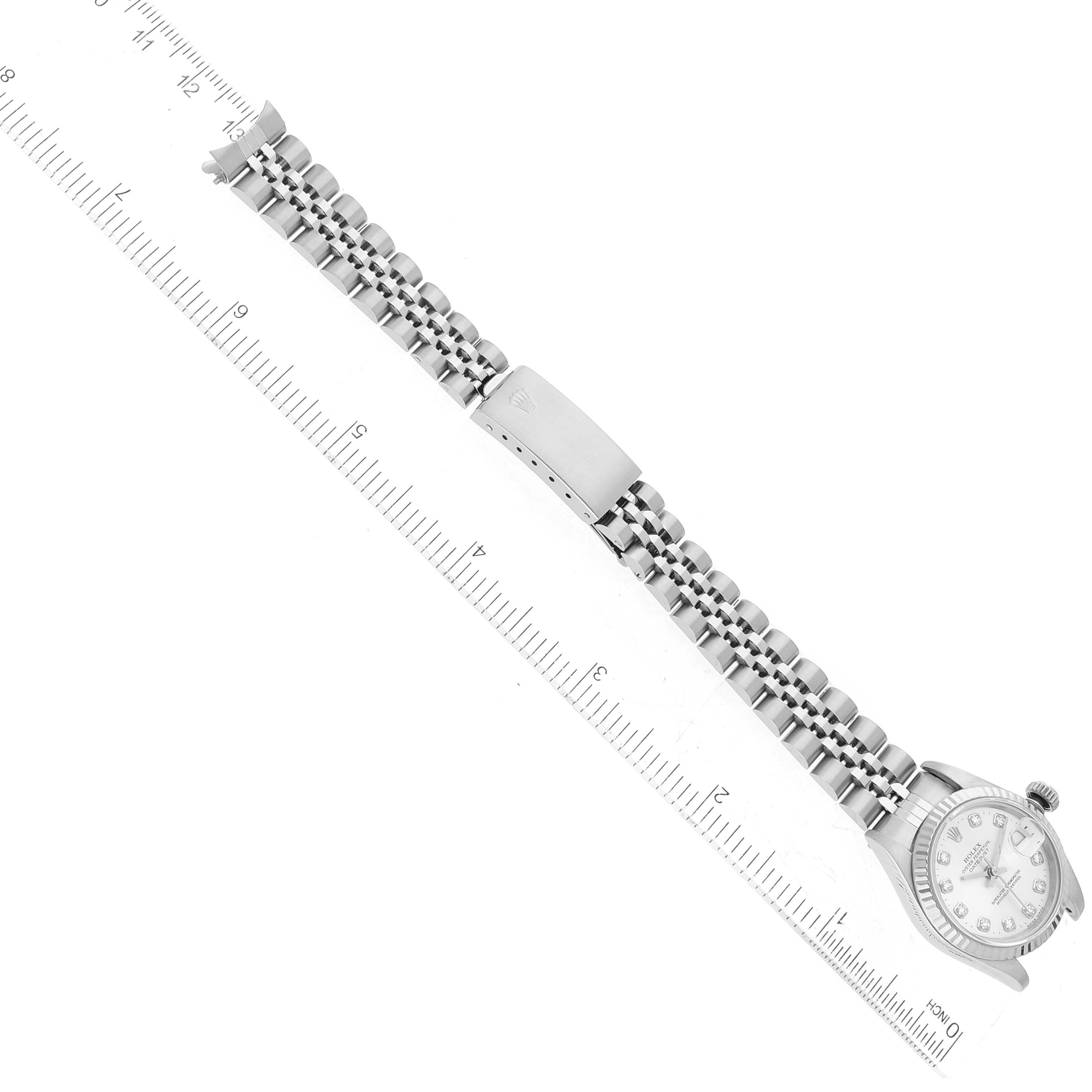 The image shows a top-down view of a Rolex Datejust 69174 Women's Stainless Steel Silver Dial 69174 Women's Stainless Steel Silver Dial model watch alongside a ruler for scale.