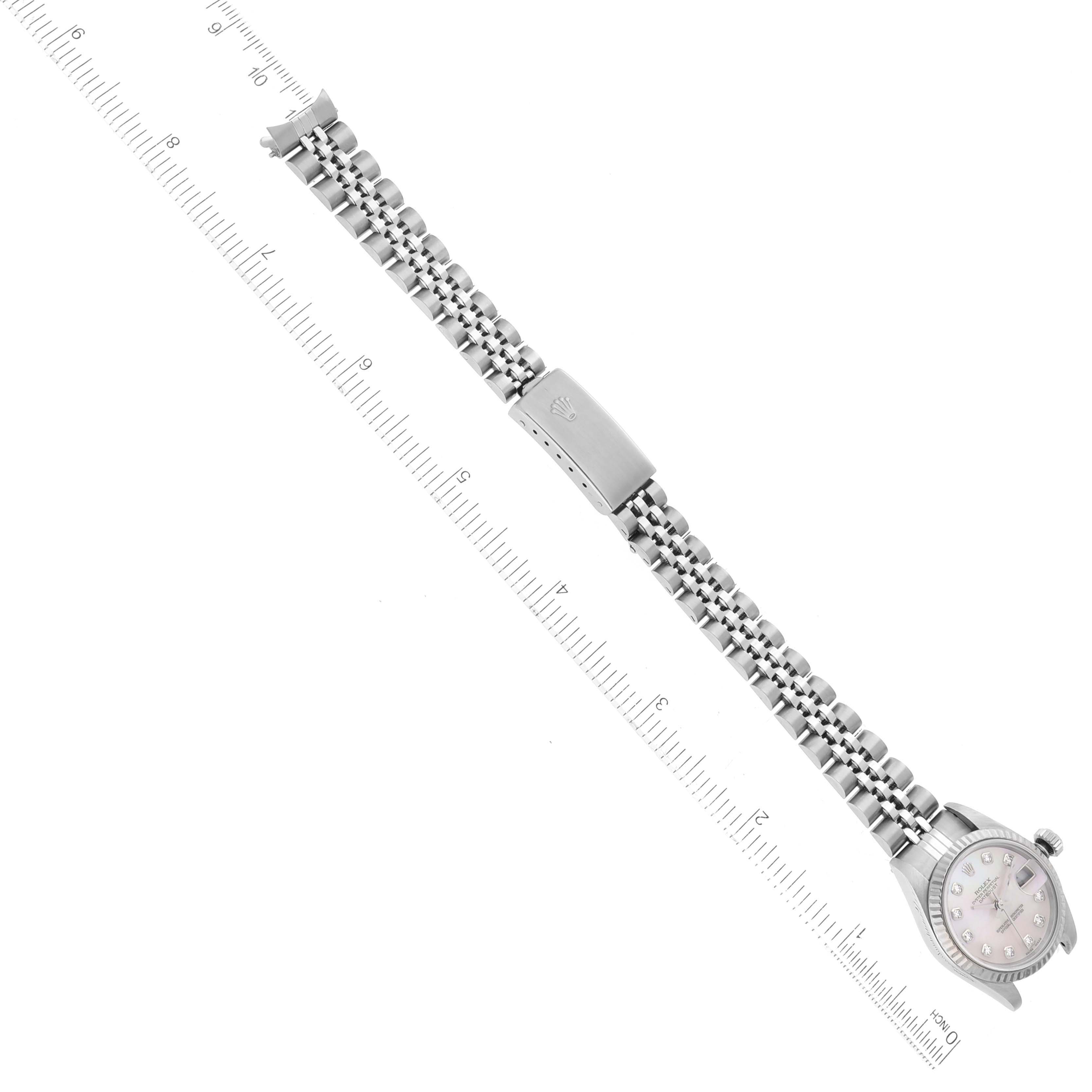 The image shows a side view of a Rolex Datejust 79174 Women's Stainless Steel Mother of Pearl Dial 79174 Women's Stainless Steel Mother of Pearl Dial watch with its bracelet fully extended and aligned with a ruler.