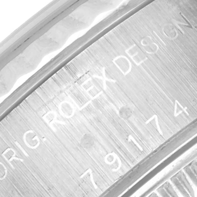 The image shows a close-up of the engraved inner bezel of a Rolex Datejust 79174 Women's Stainless Steel Mother of Pearl Dial 79174 Women's Stainless Steel Mother of Pearl Dial model.