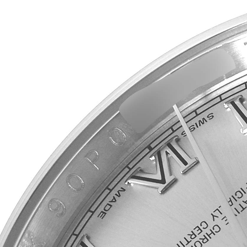 This close-up angle of a Rolex Datejust 116234 Men
s Stainless Steel Silver Dial 116234 Men
s Stainless Steel Silver Dial watch shows the edge of the dial with Roman numerals and a portion of the bezel.