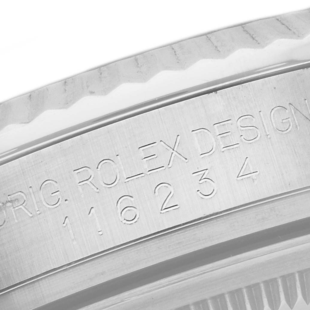 The image shows the side of the casing of a Rolex Datejust 116234 Men
s Stainless Steel Silver Dial 116234 Men
s Stainless Steel Silver Dial watch, displaying engraved text with the model number 116234.