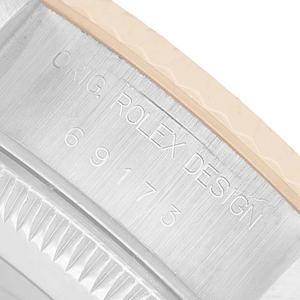 The image shows an angled close-up of the Rolex Datejust 69173 Women's Steel and Gold (two tone) Champagne Dial model's case, highlighting the engraved design and reference number.