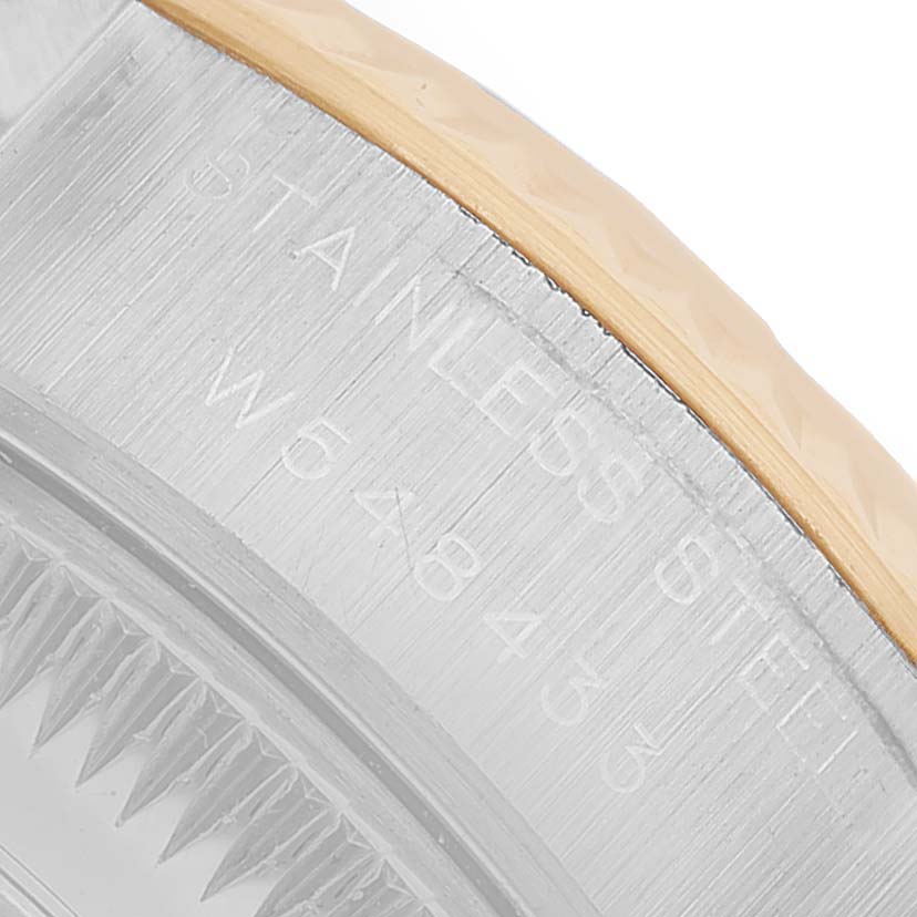 The image shows a close-up of the side and edge of the bezel on a Rolex Datejust 69173 Women's Steel and Gold (two tone) Champagne Dial model, highlighting the stainless steel and gold detail.