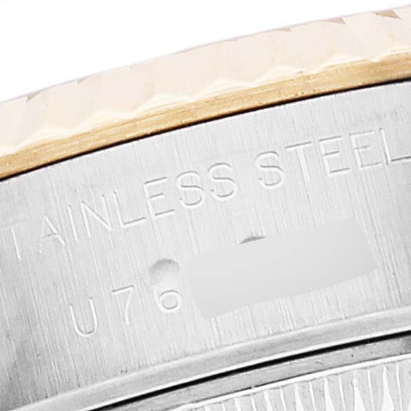 The image shows a close-up of the side of a Rolex Datejust 69173 Women's Steel and Gold (two tone) Blue Dial 69173 Women's Steel and Gold (two tone) Blue Dial watch, highlighting its stainless steel and serial number engraving.