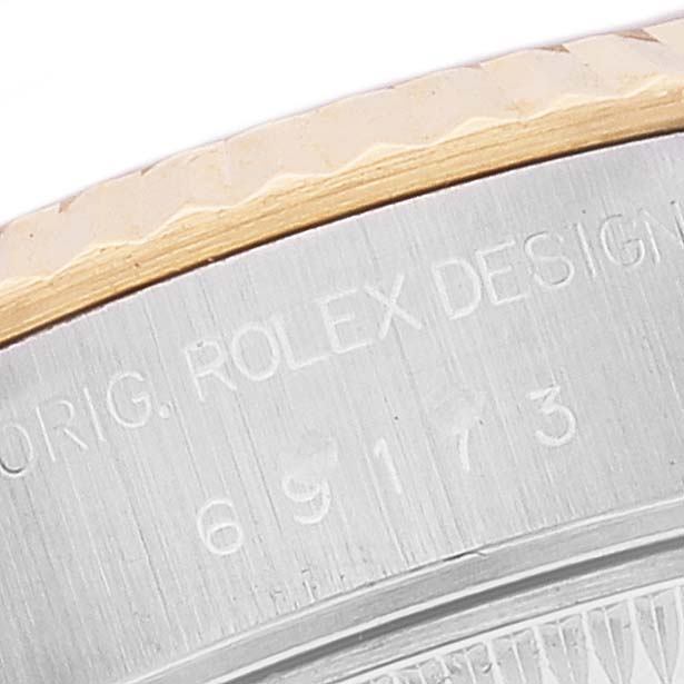 This is a close-up shot of the case back edge and model number engraving on a Rolex Datejust 69173 Women's Steel and Gold (two tone) Blue Dial 69173 Women's Steel and Gold (two tone) Blue Dial watch.