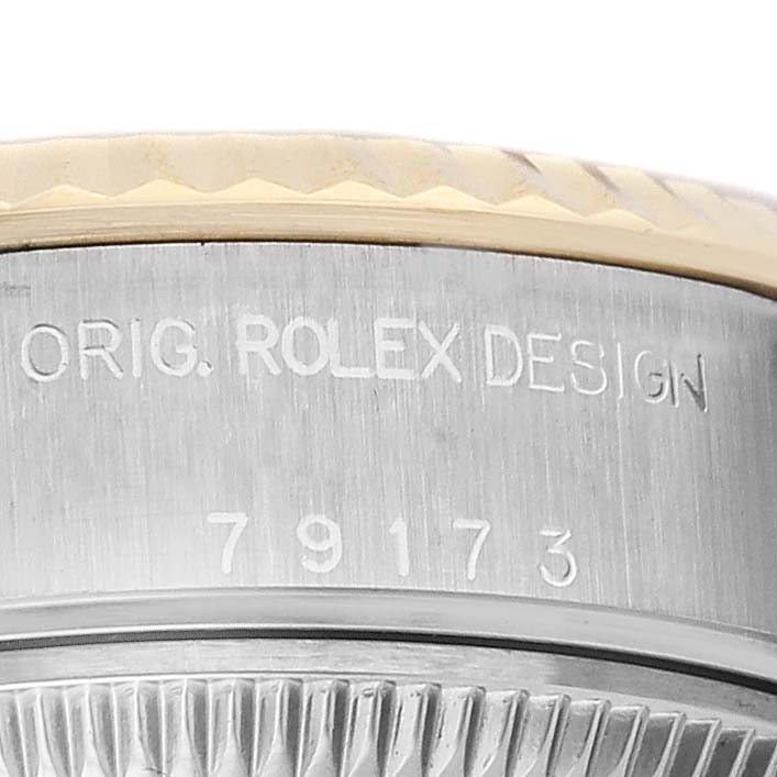 The image shows the side of a Rolex Datejust 79173 Women's Stainless Steel Champagne Dial bezel with "ORIG. ROLEX DESIGN" and the model number engraved.