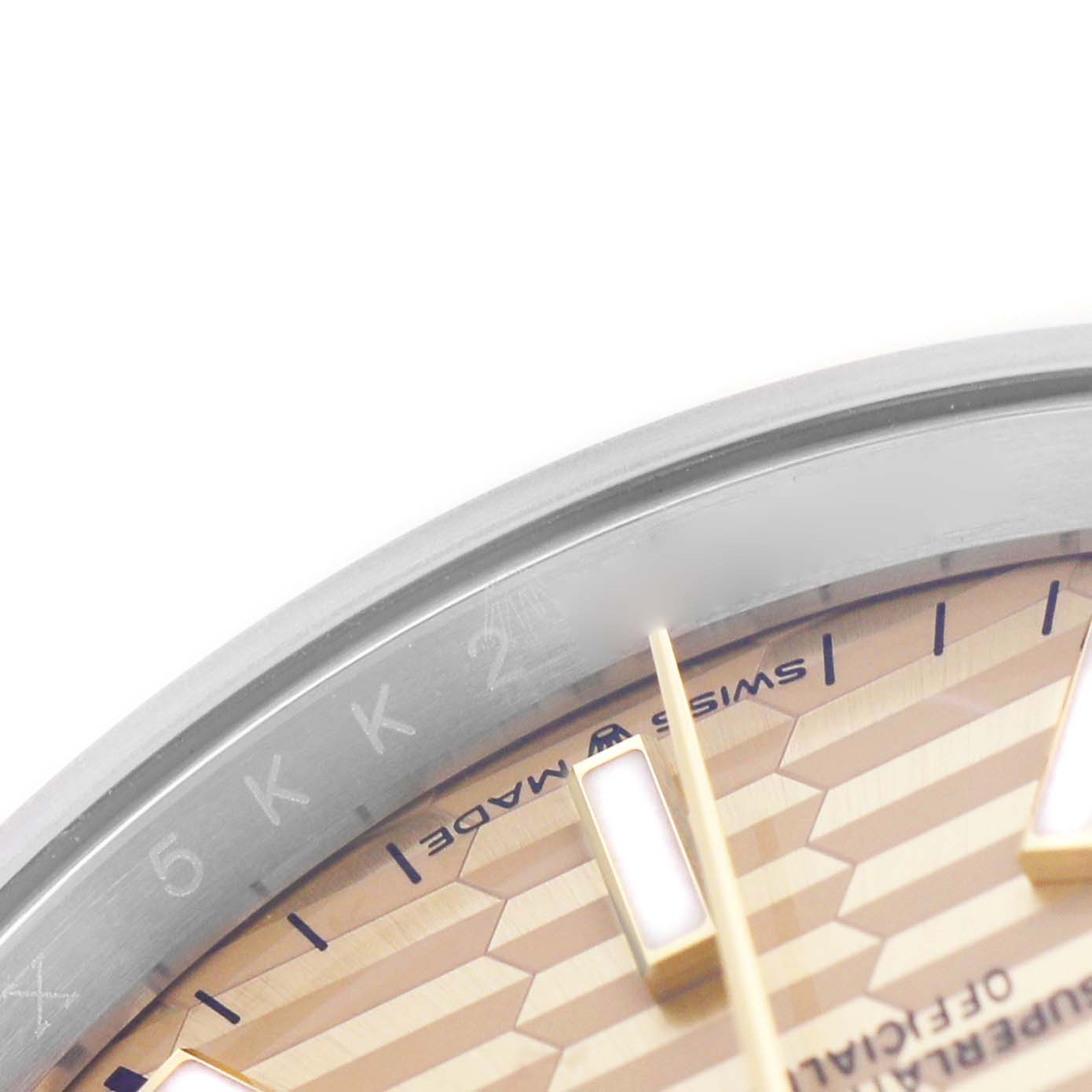 The image shows a close-up of the dial edge and hour marker of a Rolex Datejust 126233 Men's Steel and Gold (two tone) Champagne Dial, highlighting the "Swiss Made" marking.
