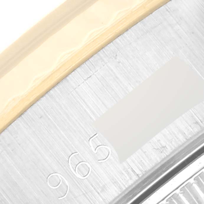 This image shows a close-up of the Rolex Datejust 69173 Women's Steel and Gold (two tone) Champagne Dial 69173 Women's Steel and Gold (two tone) Champagne Dial watch, highlighting part of the bezel and the serial number engraving.