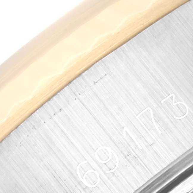 This close-up image shows part of the case with engraved numbers on a Rolex Datejust 69173 Women's Steel and Gold (two tone) Champagne Dial 69173 Women's Steel and Gold (two tone) Champagne Dial watch.