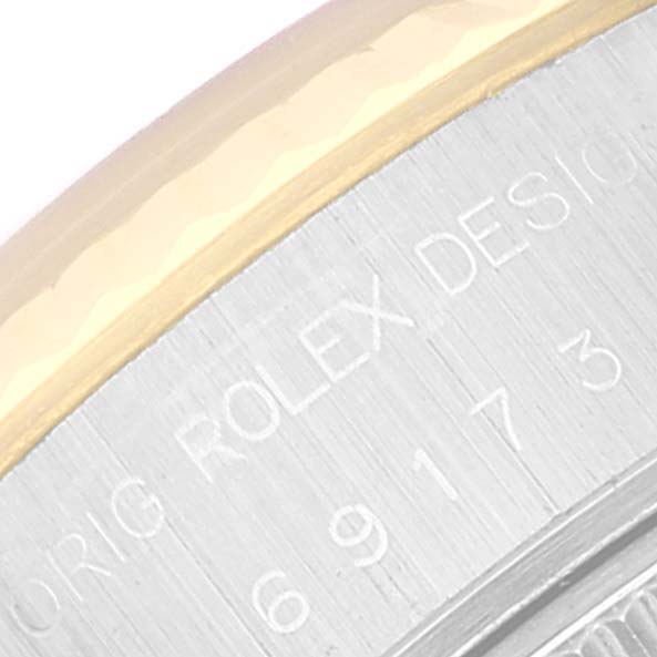 This close-up shows the engraved text on the bezel and caseback of a Rolex Datejust 69173 Women's Steel and Gold (two tone) White Dial 69173 Women's Steel and Gold (two tone) White Dial watch.